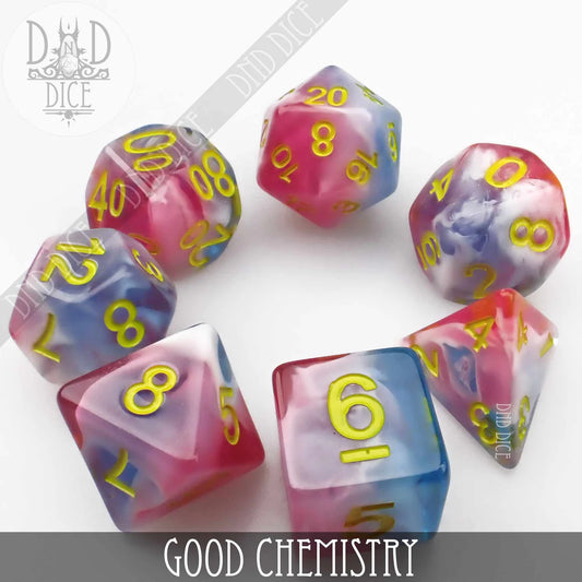 Colorful resin dice for tabletop games featuring vibrant pink and blue designs with golden numbers