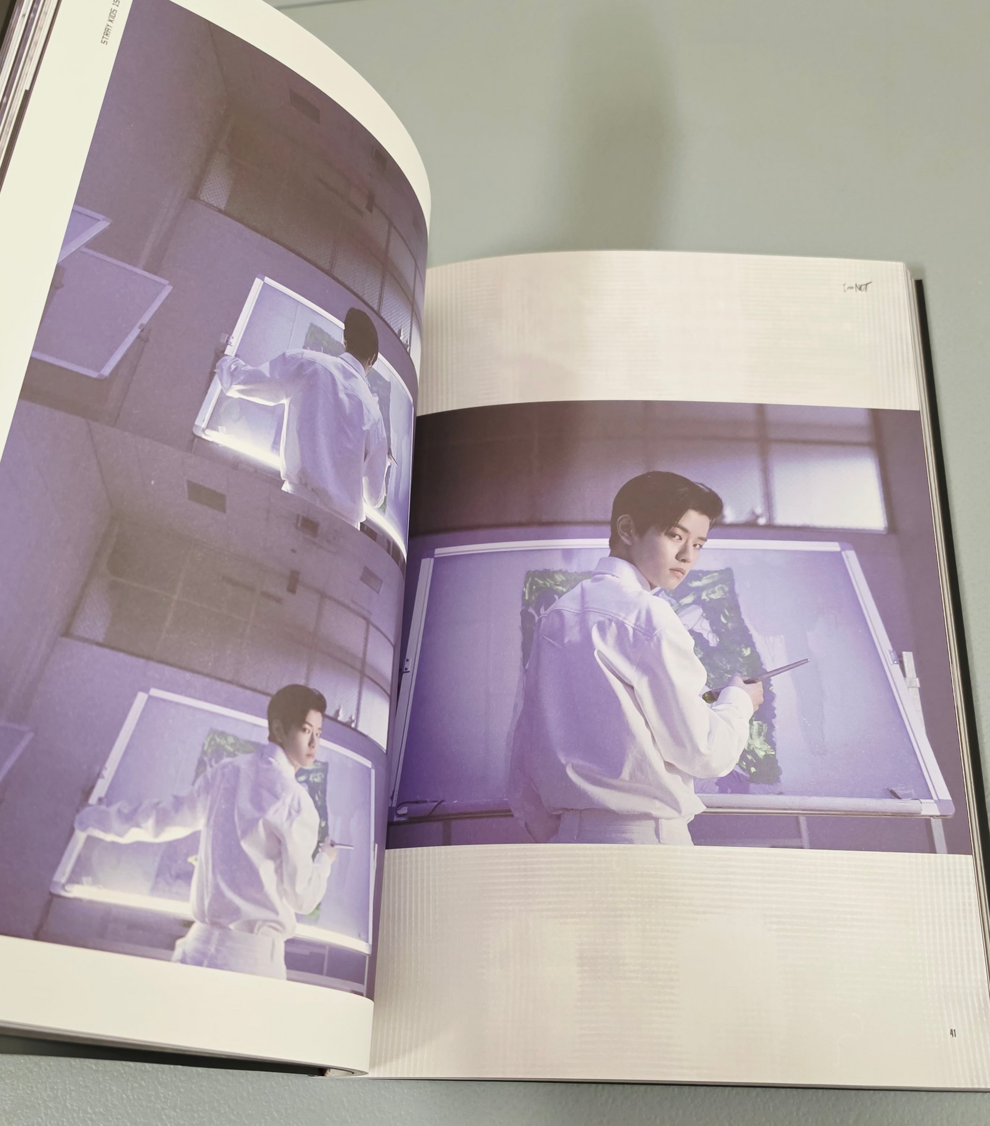 JYP ENT K-Pop album featuring artist in a white outfit with vibrant images inside