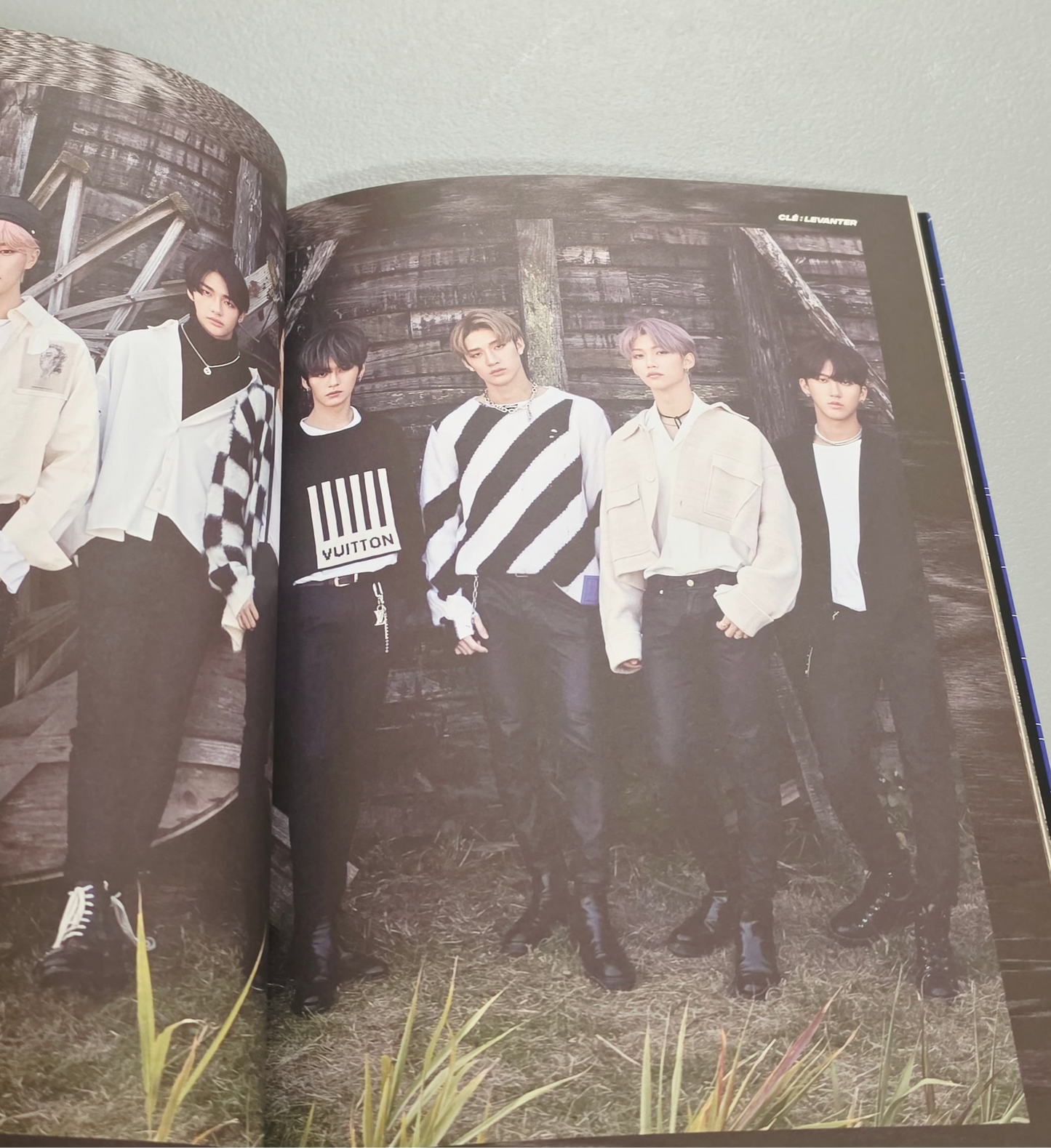 Stray Kids merch photo book featuring all members in stylish outfits, showcasing JYP Entertainment branding