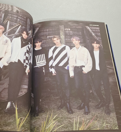 Stray Kids merch photo book featuring all members in stylish outfits, showcasing JYP Entertainment branding